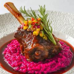 Slow braised lamb shank on beetroot risotto, lamb gravy and modern gremolata