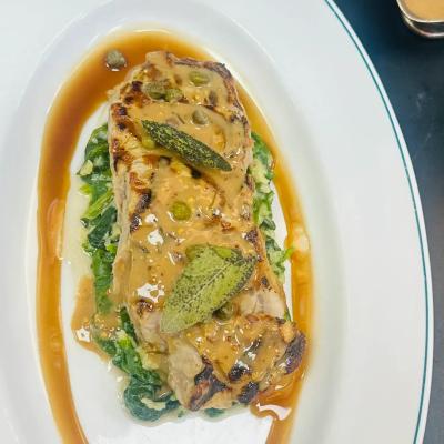 sirloin with butter spinach and pepper corn sauce and sage on top