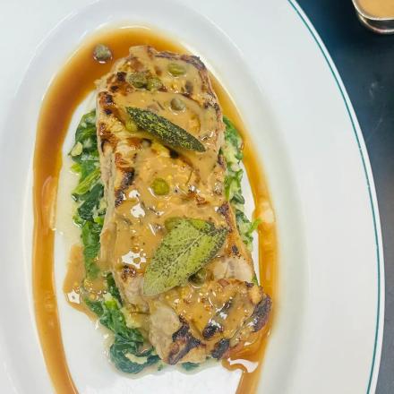 sirloin with butter spinach and pepper corn sauce and sage on top