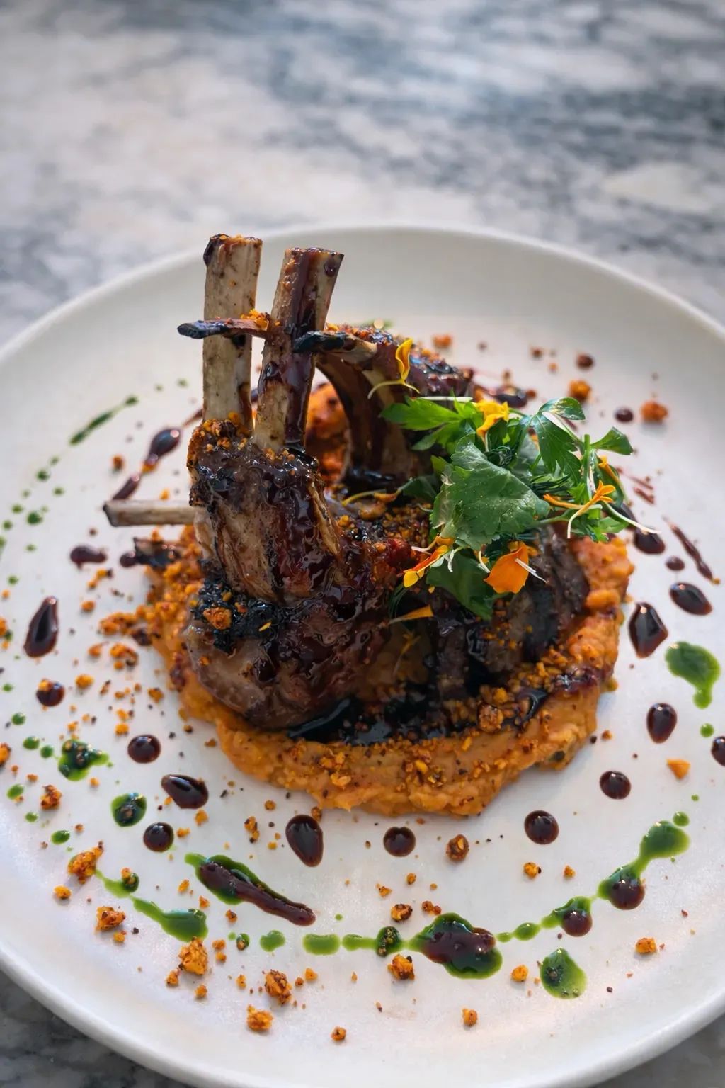 Charcoal-Grilled Lamb Chops with Sweet Potato Purée, Herb Oil & Red Wine Jus